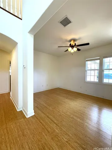 a view of a livingroom with a ceiling fan and window