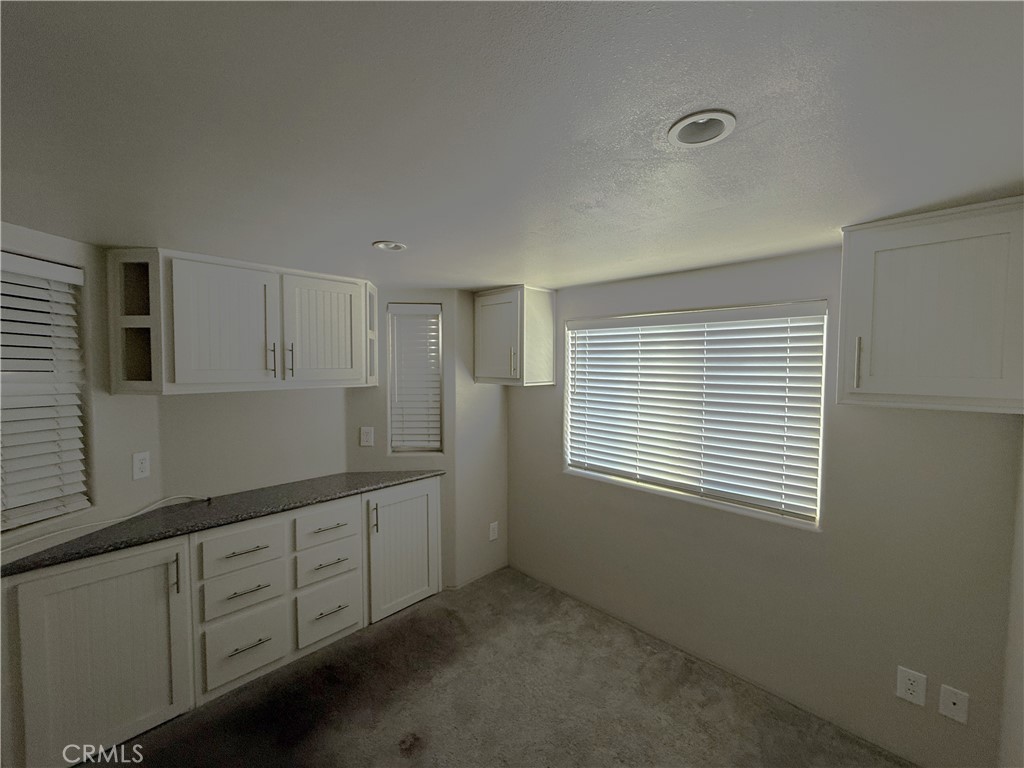 4849 Peck Road, Unit 67 El Monte, CA 91732 - Photo 8 of 13 a room with cabinets and wooden floor