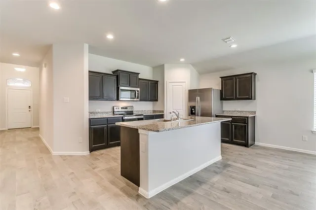 a kitchen with a sink stove and refrigerator