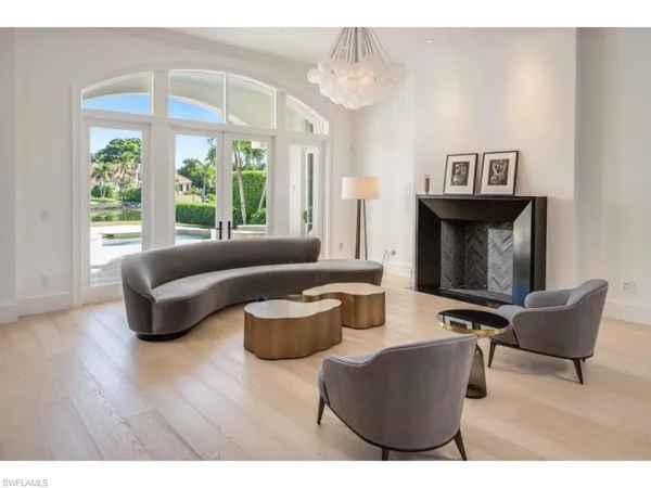 a living room with furniture and a floor to ceiling window