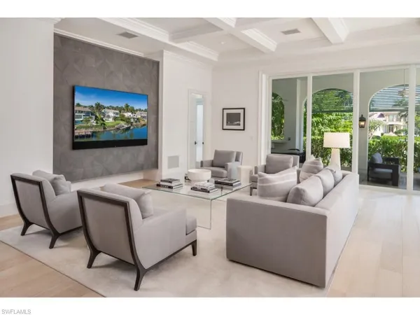 a living room with furniture a large window and a flat screen tv