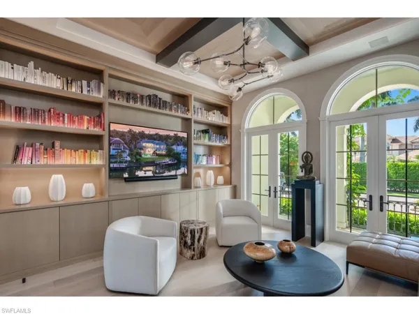 a living room with furniture a window and a flat screen tv
