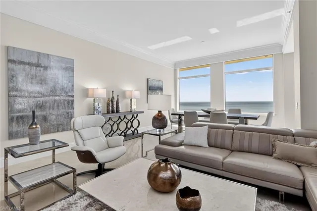 a living room with furniture a rug and a window