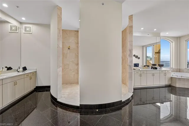 a large kitchen with kitchen island a sink appliances and a large window