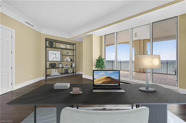 an empty room with wooden floor and windows with curtains