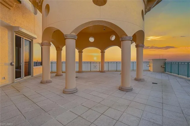 a view of a roof deck with table and chairs and potted plants