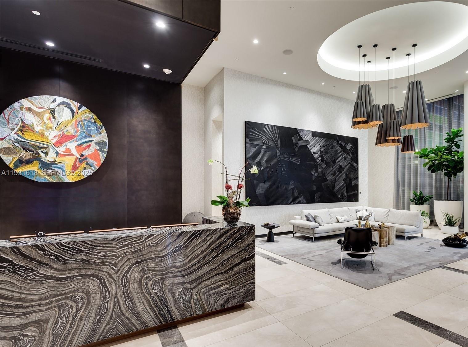 55 Southwest 9th Street, Unit 3707 Miami, FL 33130 - Photo 20 of 25 a bedroom with a bed and glass wall