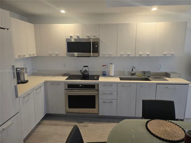 a kitchen with a sink and cabinets
