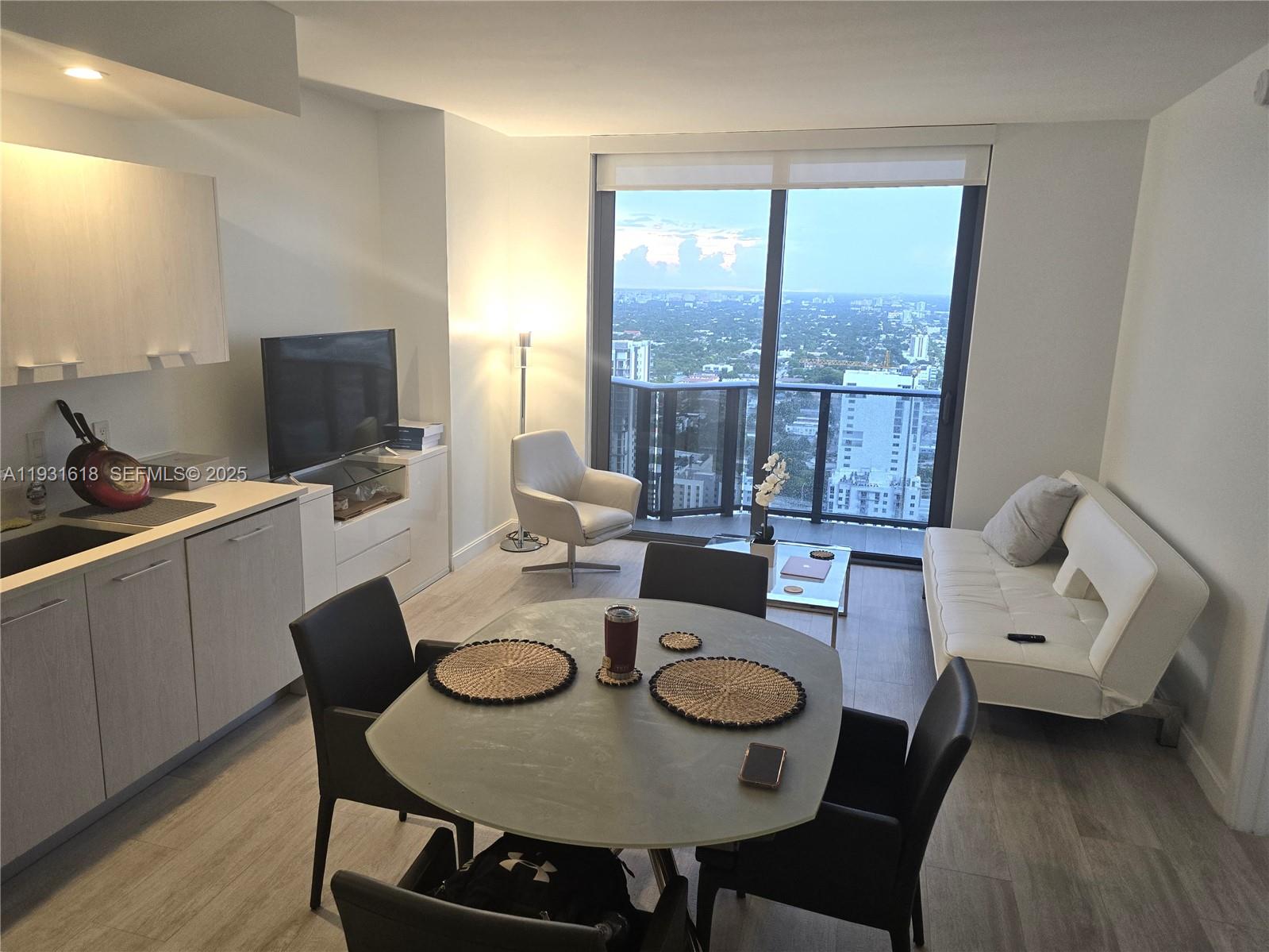 55 Southwest 9th Street, Unit 3707 Miami, FL 33130 - Photo 6 of 25 a living room with furniture and a table