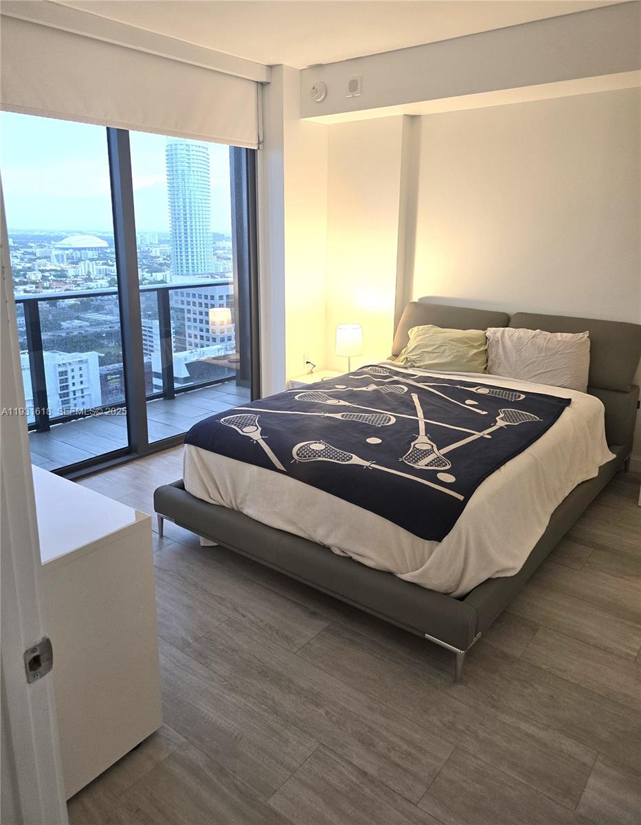 55 Southwest 9th Street, Unit 3707 Miami, FL 33130 - Photo 9 of 25 a bed sitting in a spacious bedroom next to a window