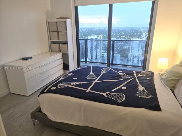 a bed sitting in a bedroom next to a window