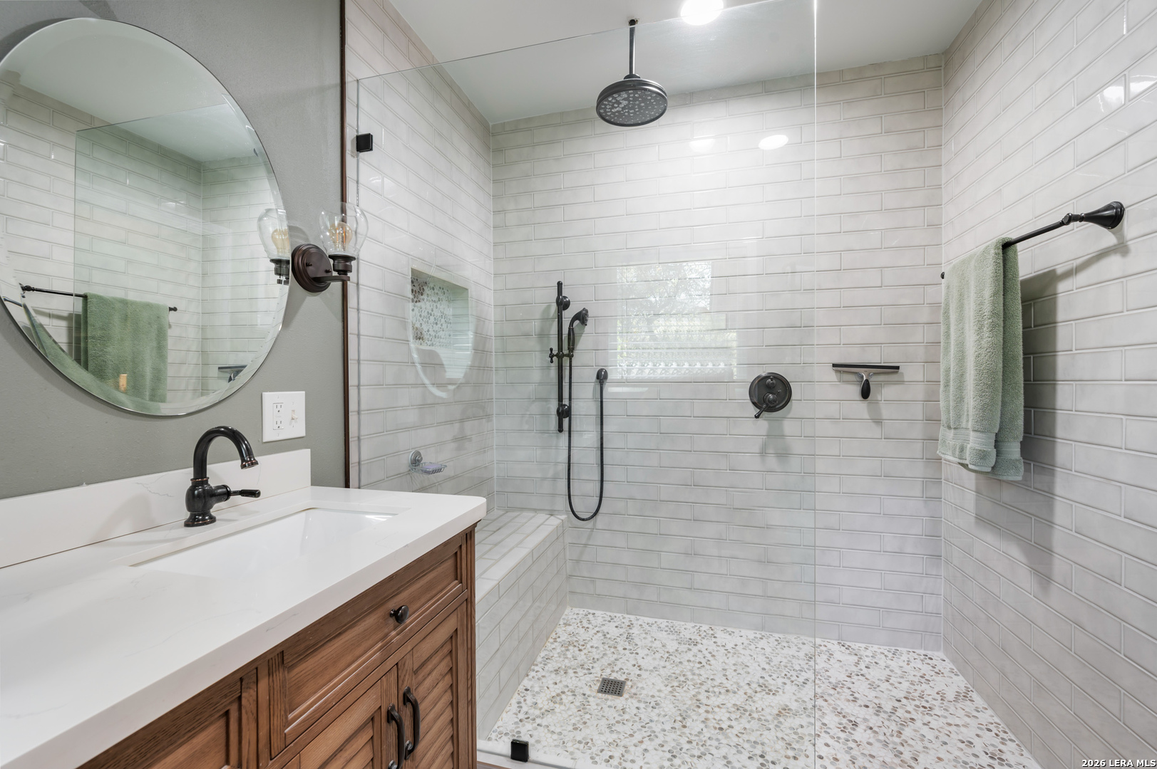 114 Wagon Trail Road Shavano Park, TX 78231 - Photo 26 of 36 a bathroom with a sink shower and a mirror