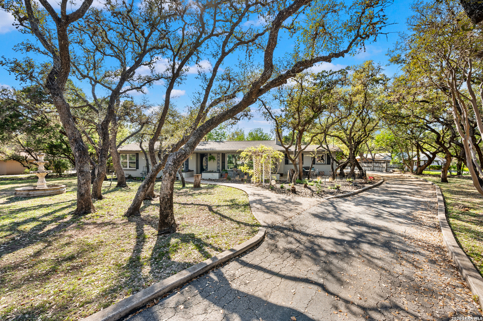 114 Wagon Trail Road Shavano Park, TX 78231 - Photo 3 of 36 a view of a yard with plants and trees