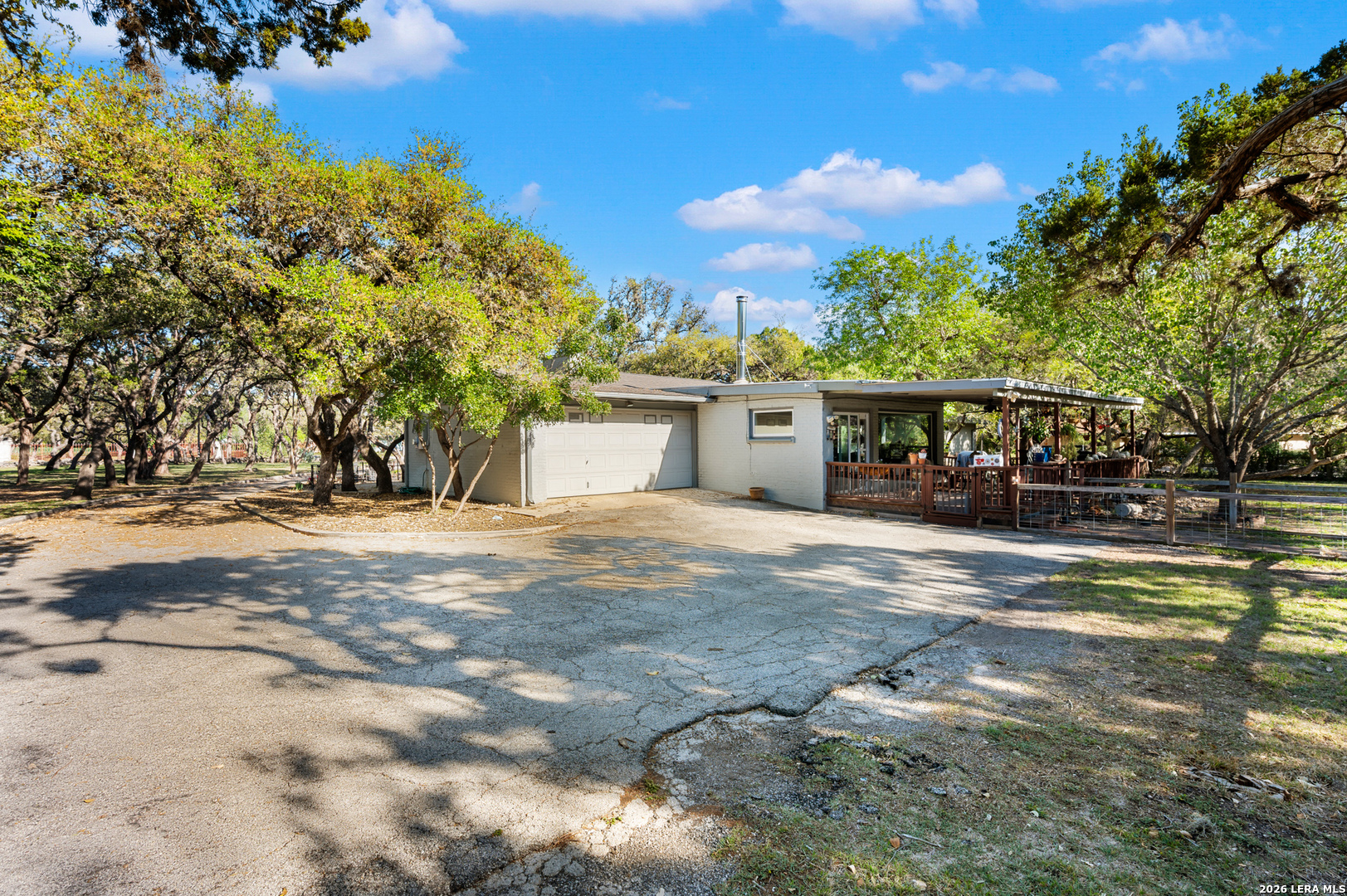 114 Wagon Trail Road Shavano Park, TX 78231 - Photo 32 of 36 a view of a white house with a yard