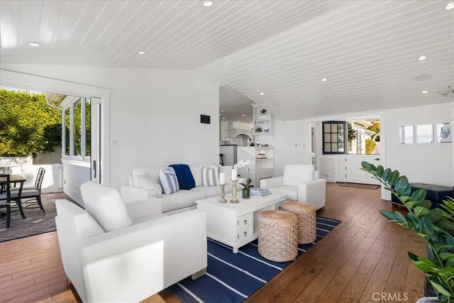 a dining room with furniture a fireplace and wooden floor