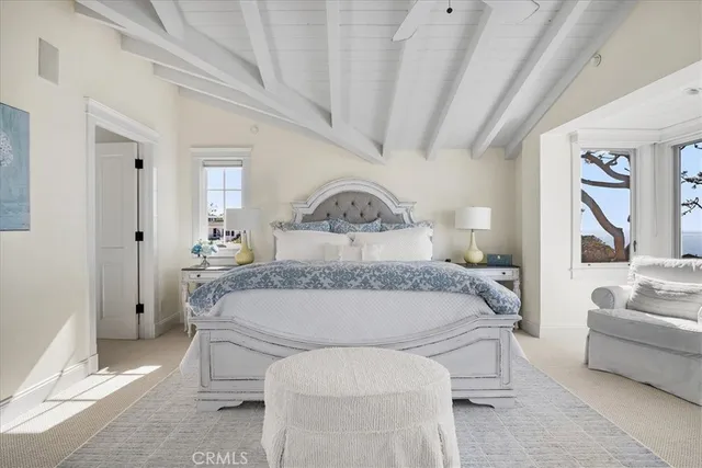 a bathroom with a granite countertop sink a toilet a mirror a vanity a bathtub and next to a window