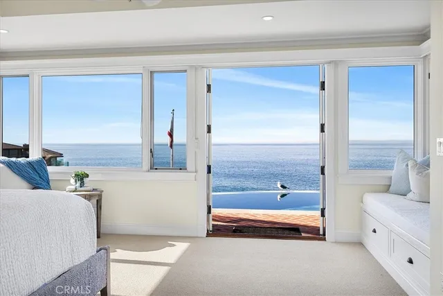 a spacious bedroom with a bed and a dresser