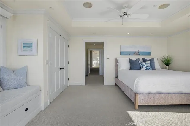 a bedroom with a bed and a lamp on the dresser