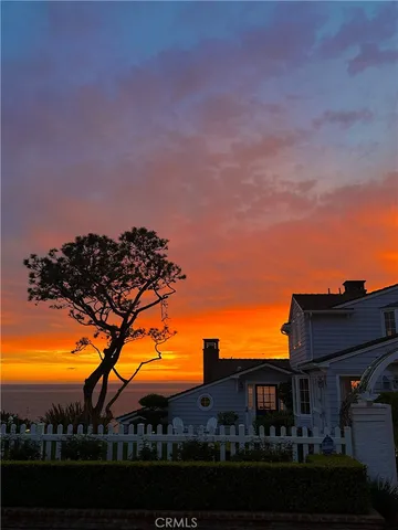 a view of a house with a yard and potted plants