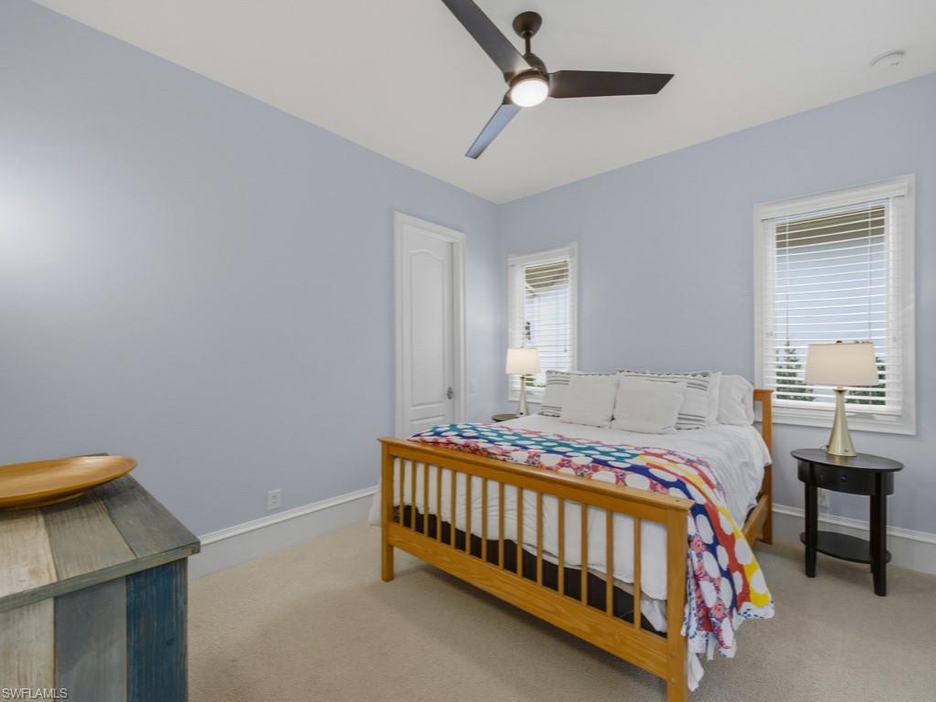 18091 Lagos Way Naples, FL 34110 - Photo 17 of 50 a bedroom with a bed and a table