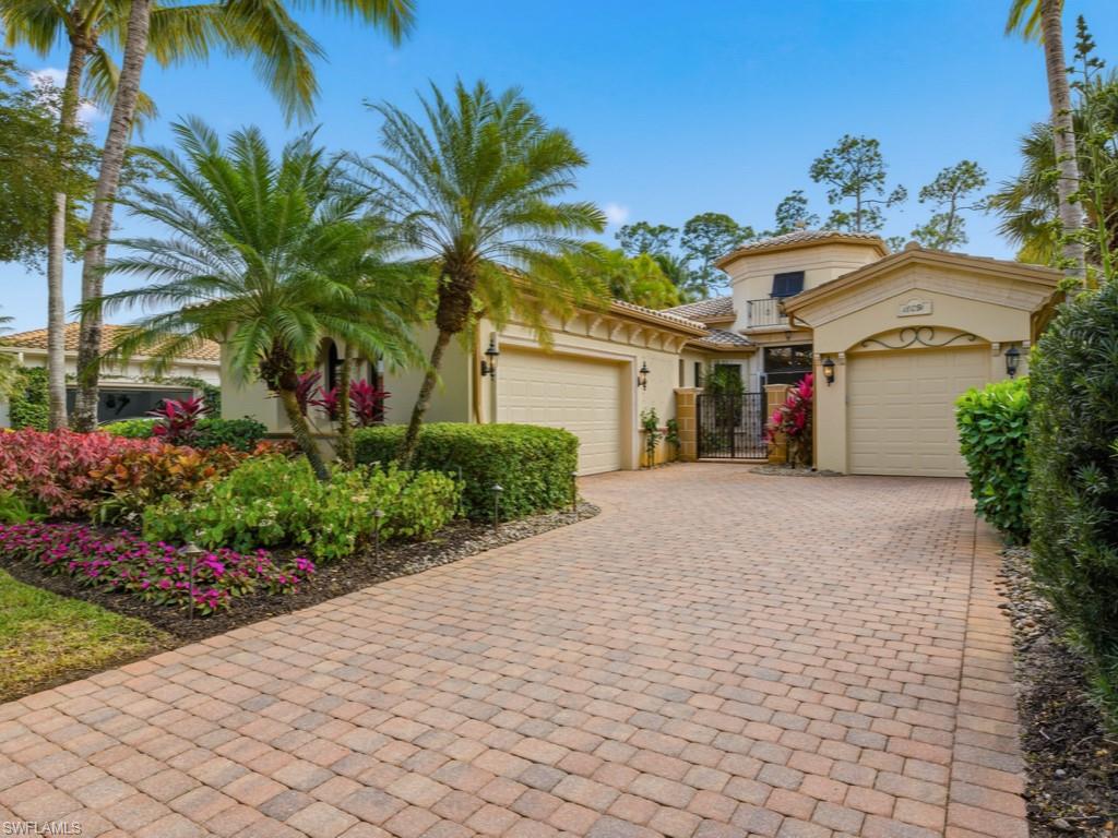 18091 Lagos Way Naples, FL 34110 - Photo 20 of 50 a front view of a house with a garden