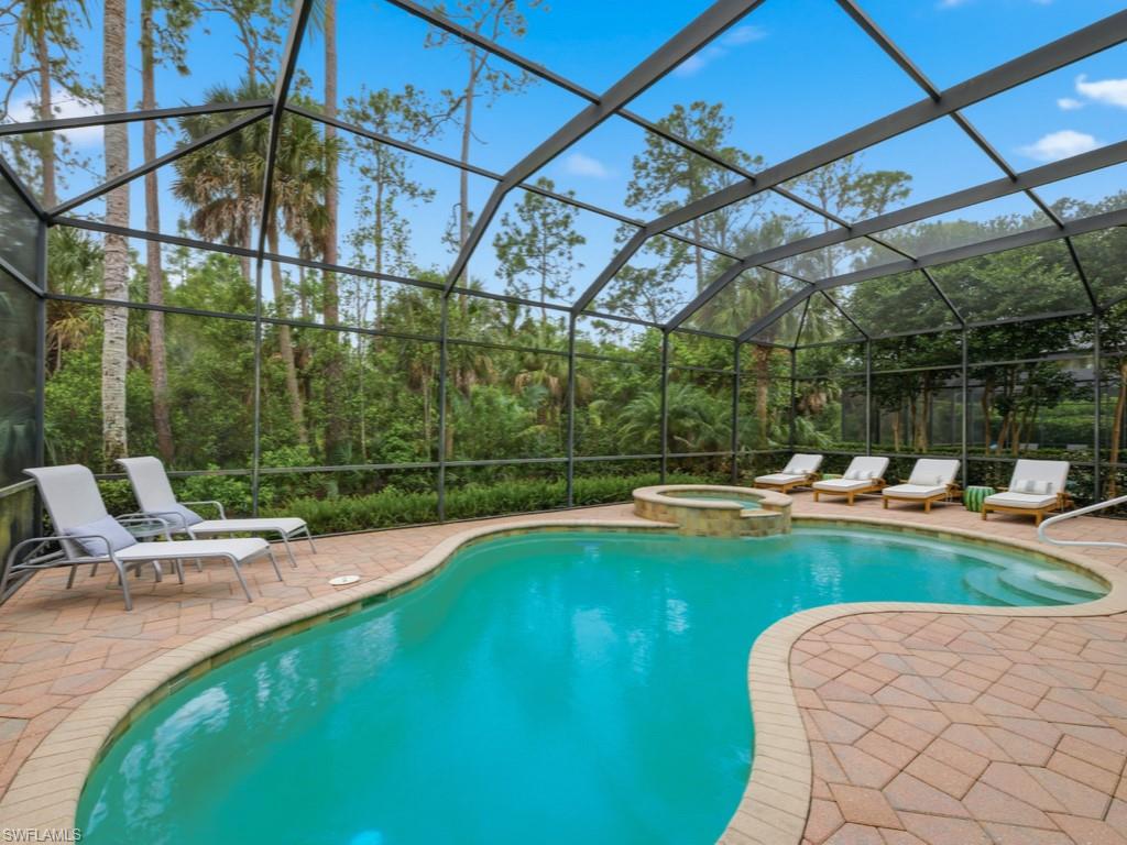 18091 Lagos Way Naples, FL 34110 - Photo 2 of 50 a view of a swimming pool with a patio