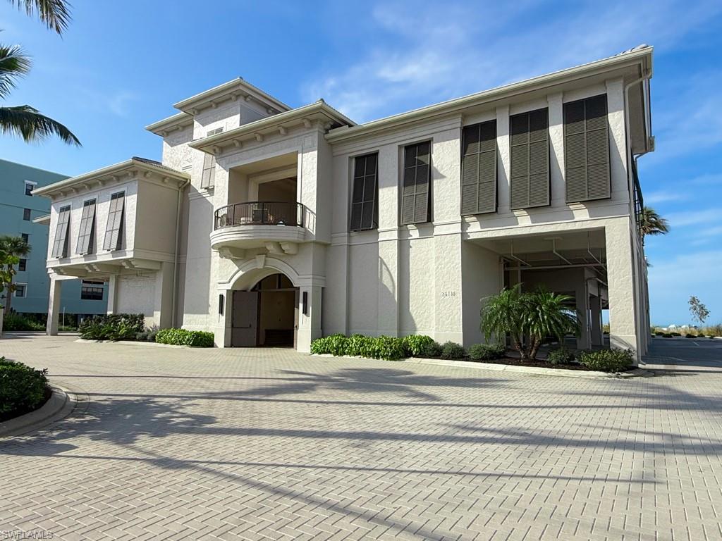 18091 Lagos Way Naples, FL 34110 - Photo 41 of 50 a front view of a house with a yard