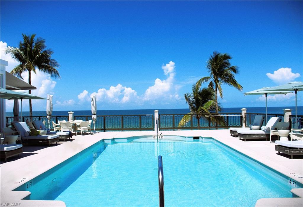 18091 Lagos Way Naples, FL 34110 - Photo 45 of 50 a swimming pool with outdoor seating