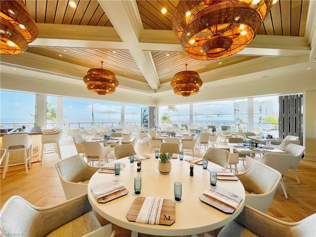 18091 Lagos Way Naples, FL 34110 - Photo 48 of 50 a dining room with lots of furniture and chandelier