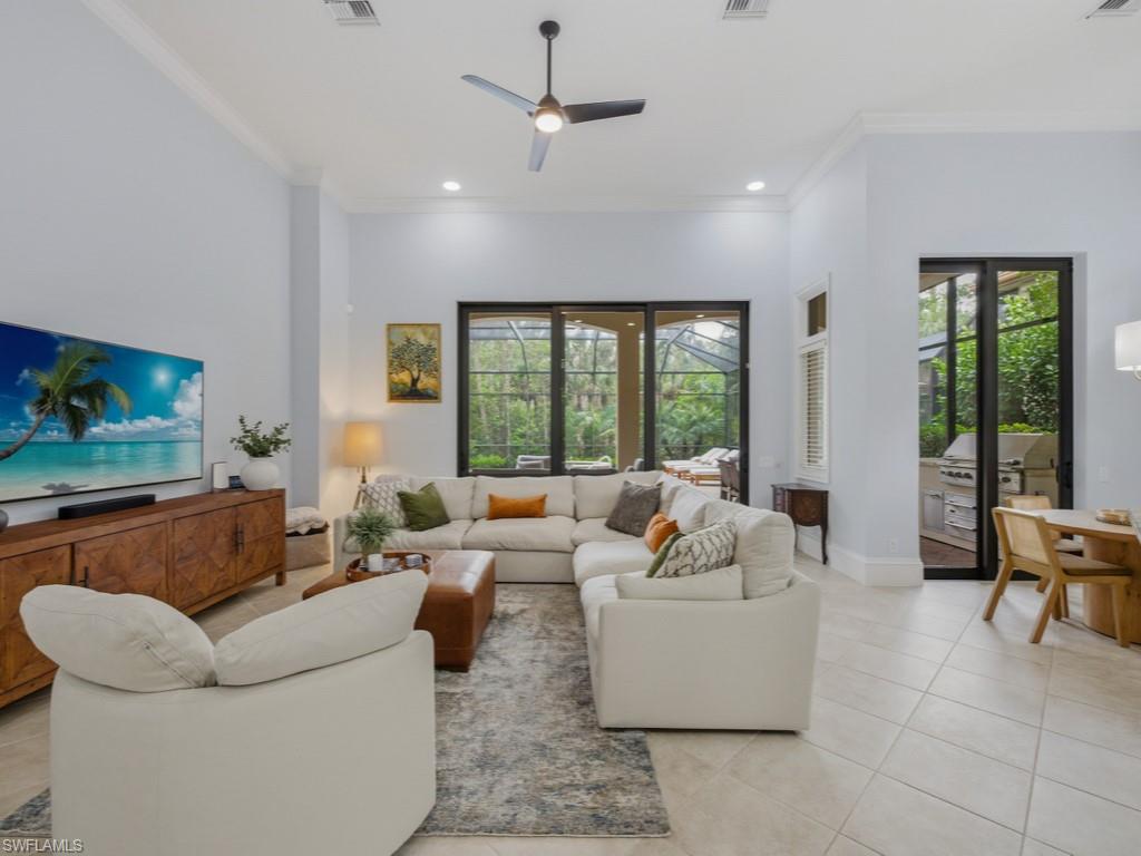 18091 Lagos Way Naples, FL 34110 - Photo 7 of 50 a living room with furniture and a flat screen tv