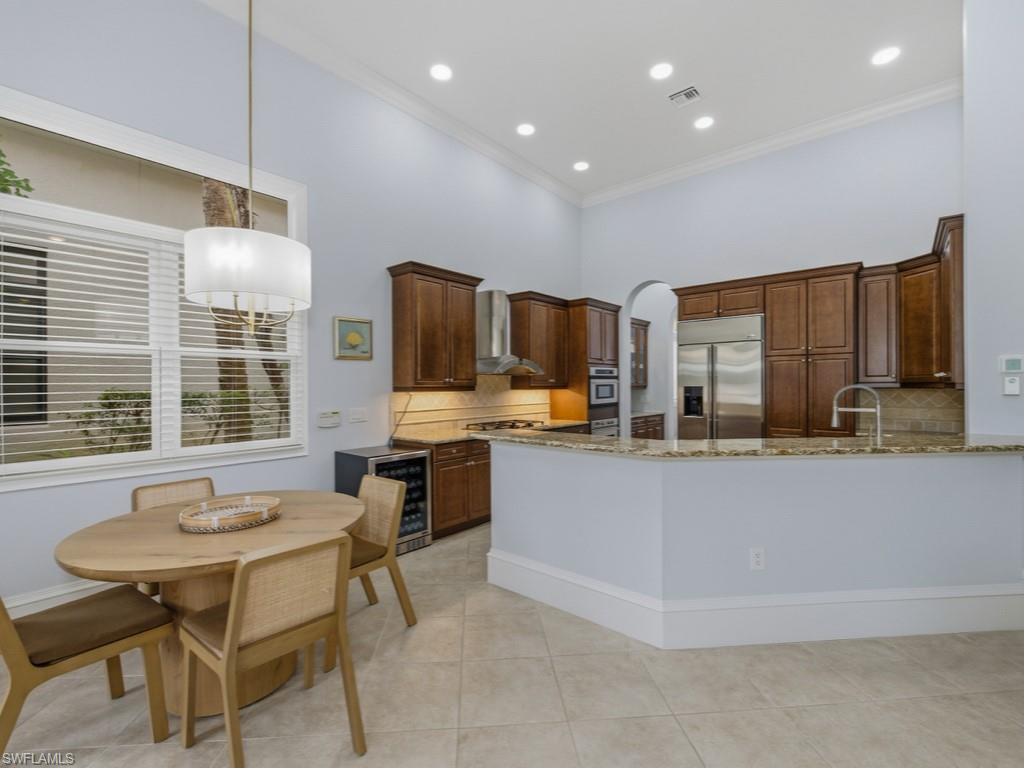 18091 Lagos Way Naples, FL 34110 - Photo 10 of 50 a living room with stainless steel appliances kitchen island granite countertop furniture and a kitchen view