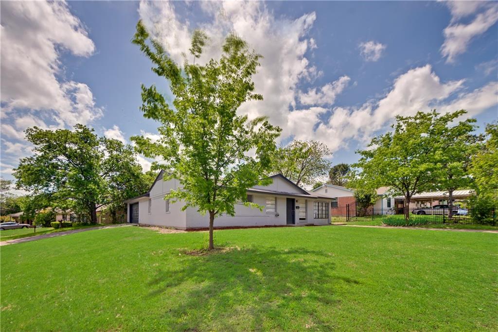 a view of an house with backyard space and garden