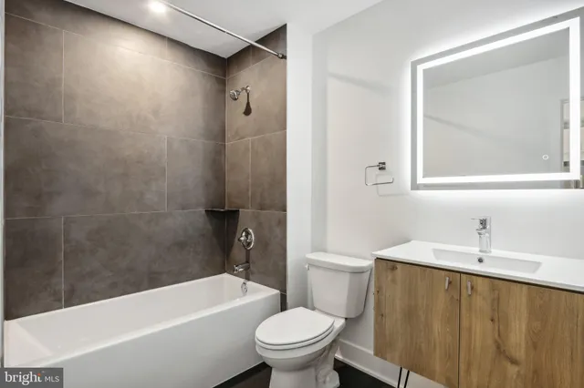 a bathroom with a sink a toilet and a bathtub