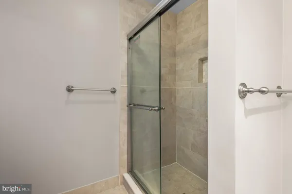 a bathroom with a glass shower door