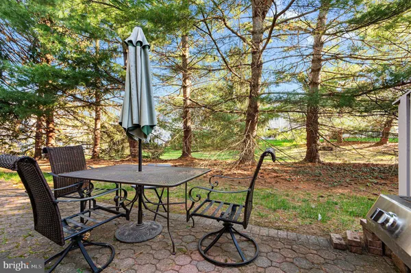 a view of a chairs and table in backyard
