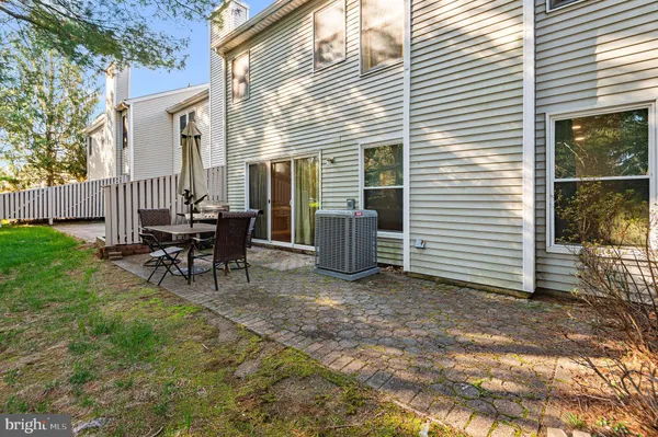 a view of a house with patio and a yard