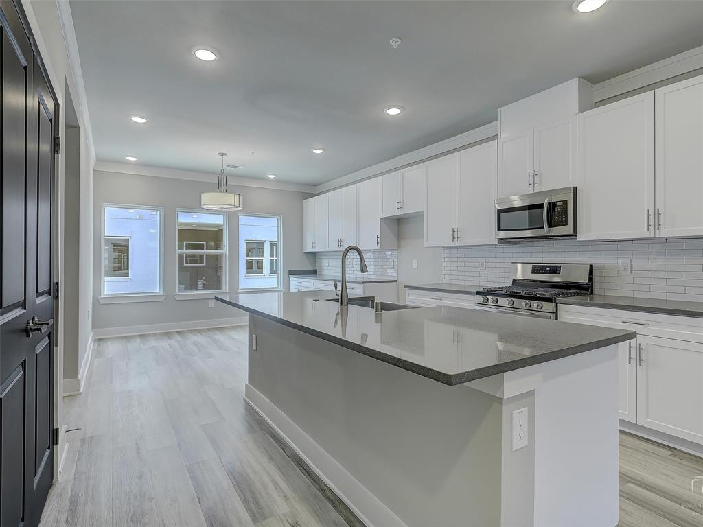3345 Wynwood Drive Plano, TX 75074 - Photo 14 of 23 a kitchen with stainless steel appliances granite countertop a sink stove and refrigerator
