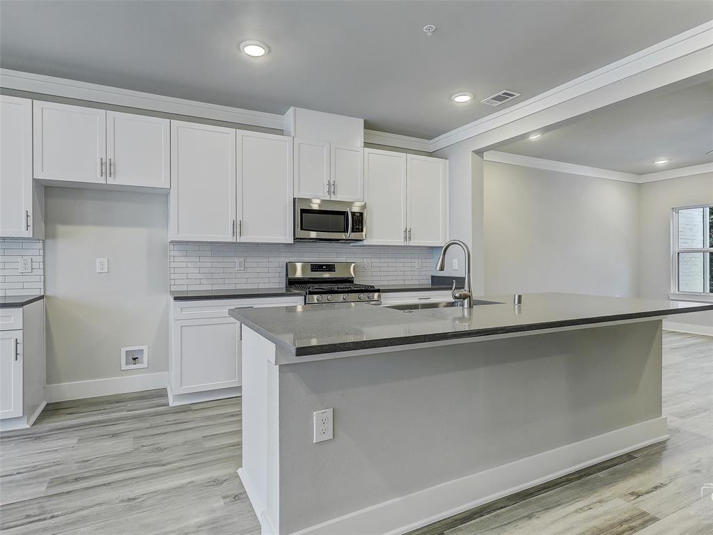 3345 Wynwood Drive Plano, TX 75074 - Photo 18 of 23 a kitchen with appliances a sink and cabinets