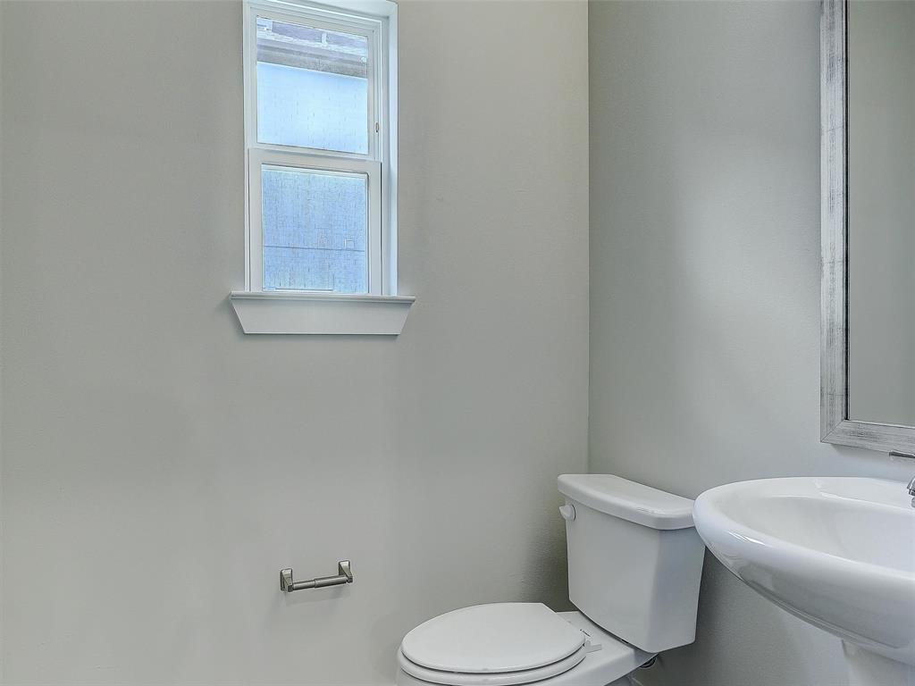3345 Wynwood Drive Plano, TX 75074 - Photo 19 of 23 a white toilet sitting next to a white sink