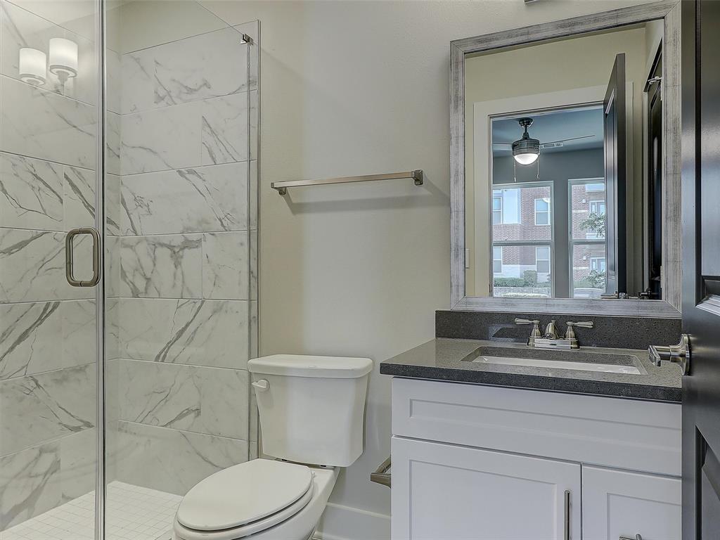 3345 Wynwood Drive Plano, TX 75074 - Photo 22 of 23 a bathroom with a sink toilet and shower