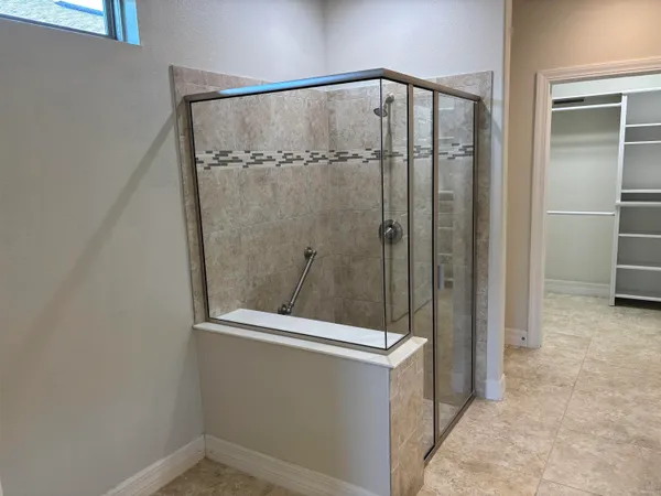 a bathroom with a glass door shower