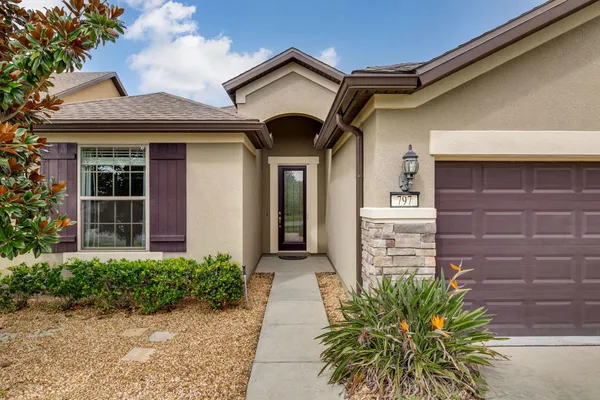 a front view of a house with a garden