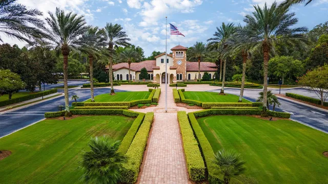 a view of swimming pool with a garden and palm trees
