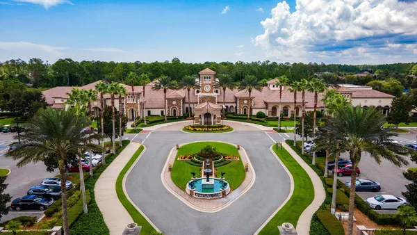 a swimming pool with outdoor seating and a garden