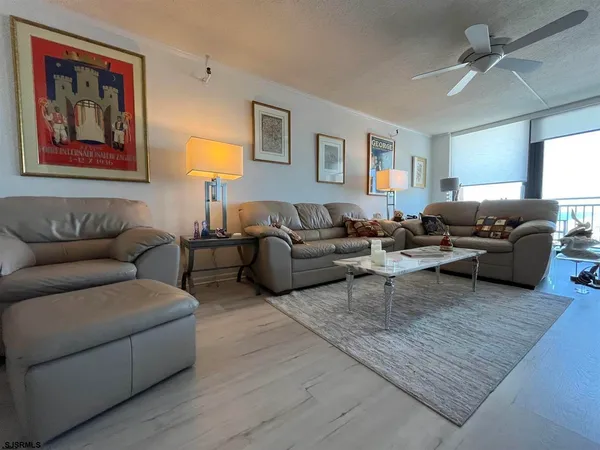 a living room with furniture and large windows