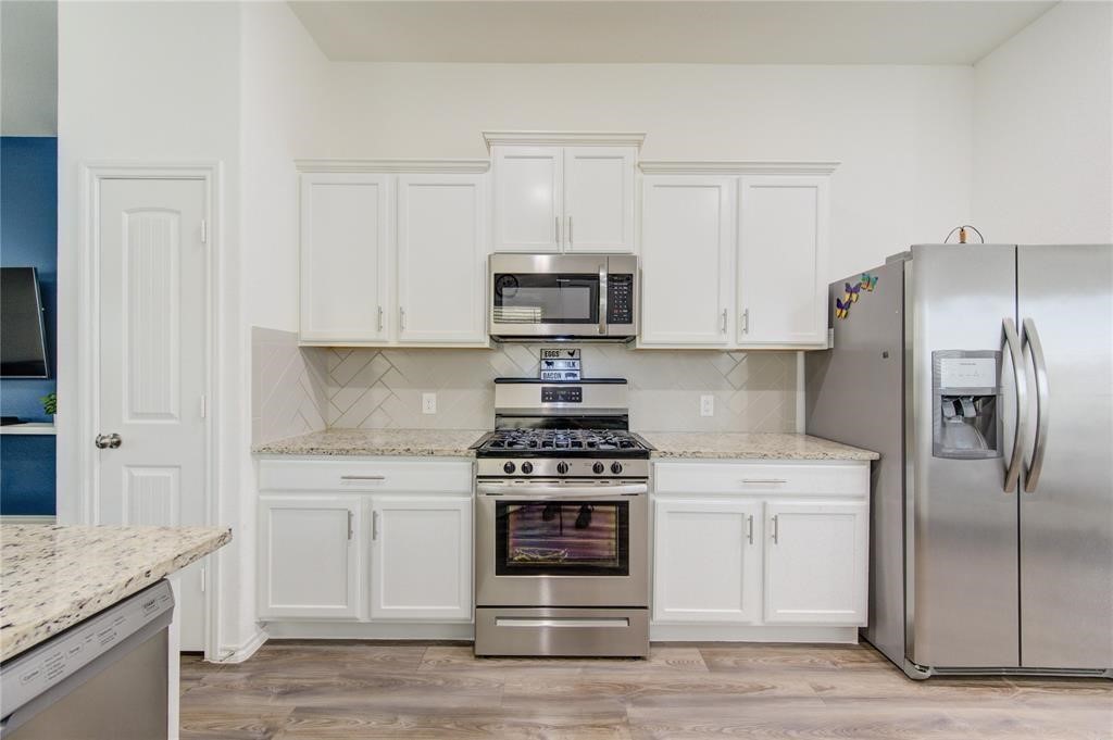 25519 Pitchfork Ranch Place Katy, TX 77493 - Photo 16 of 31 a kitchen with stainless steel appliances granite countertop a stove and a refrigerator