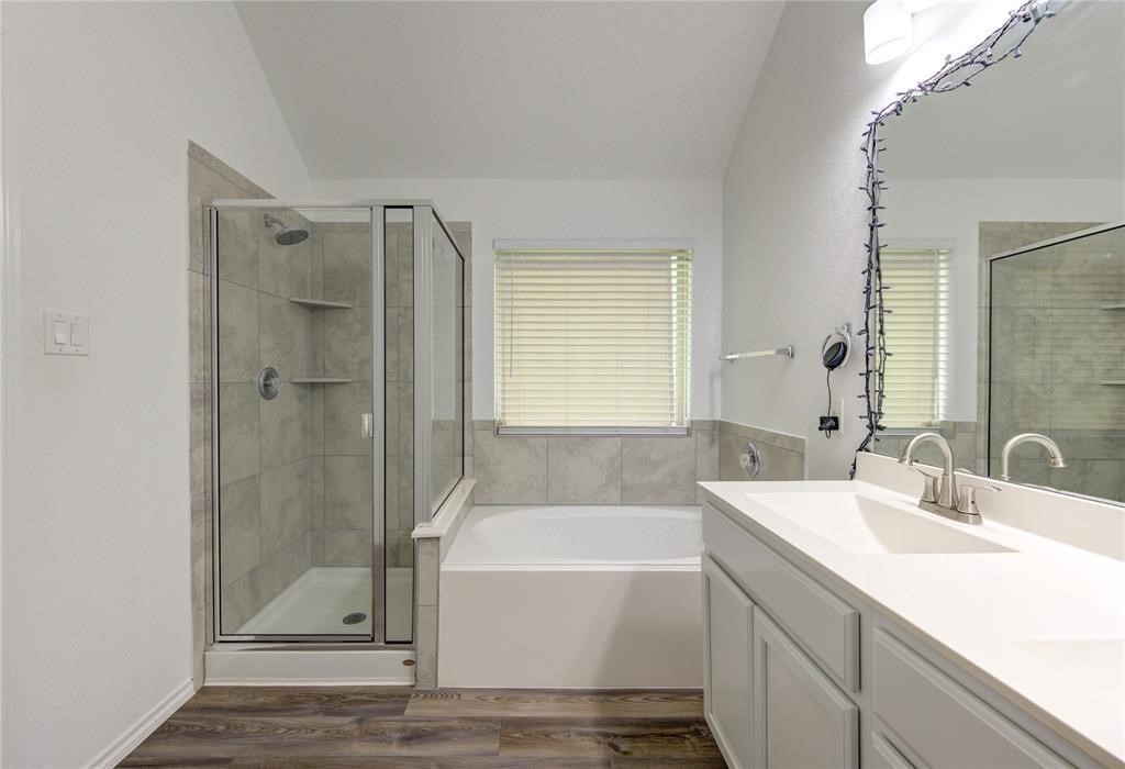 25519 Pitchfork Ranch Place Katy, TX 77493 - Photo 18 of 31 a bathroom with a tub sink shower and a mirror