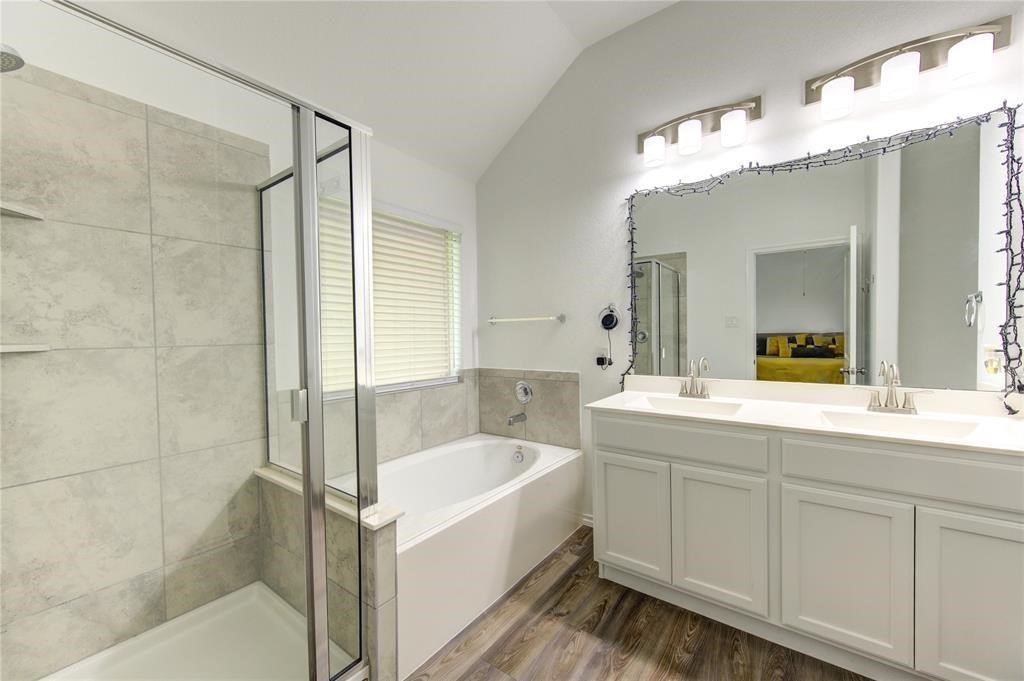 25519 Pitchfork Ranch Place Katy, TX 77493 - Photo 20 of 31 a bathroom with a tub a sink and mirror