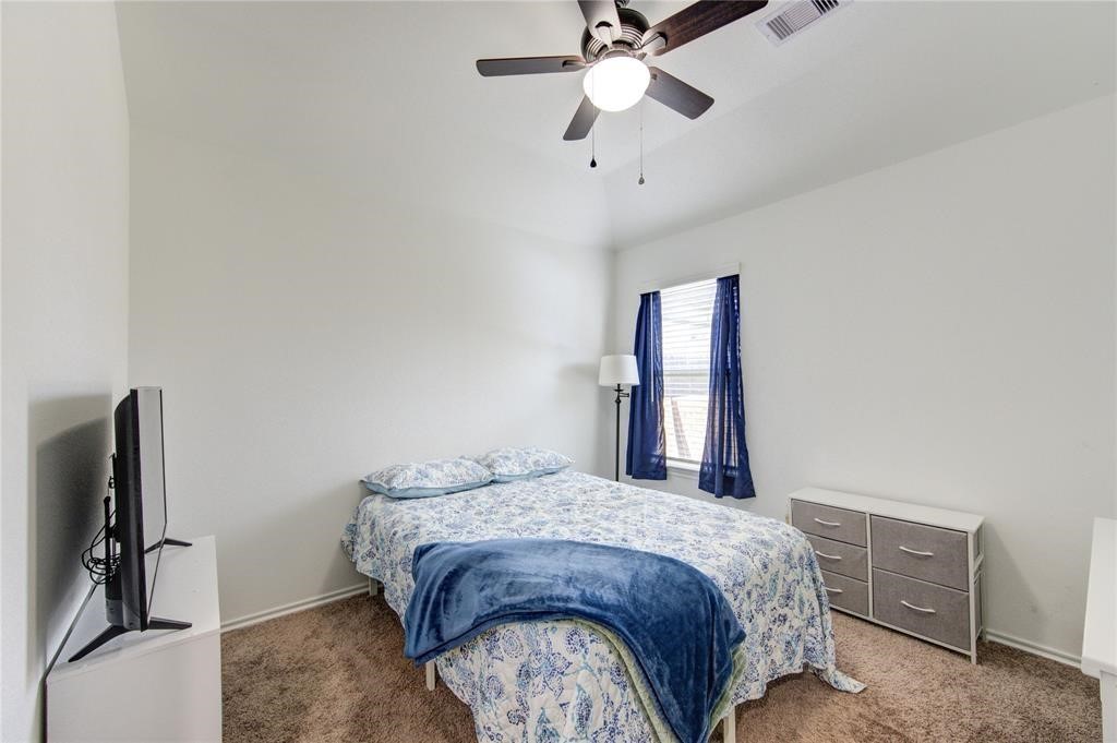 25519 Pitchfork Ranch Place Katy, TX 77493 - Photo 22 of 31 a bedroom with a bed dresser and a window