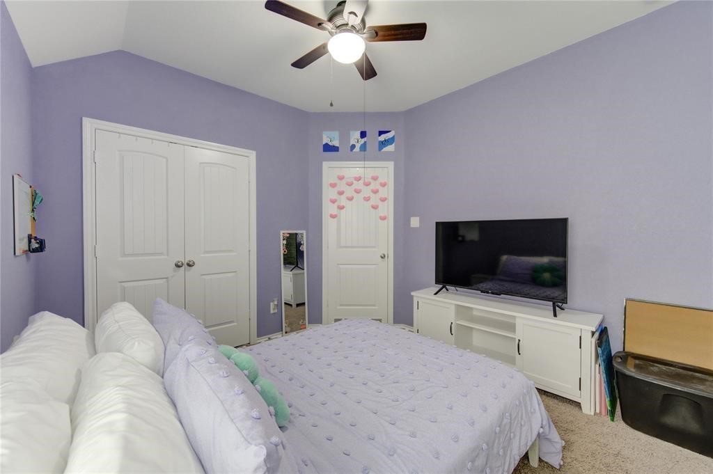 25519 Pitchfork Ranch Place Katy, TX 77493 - Photo 25 of 31 a bedroom with a bed and a flat tv screen on dresser